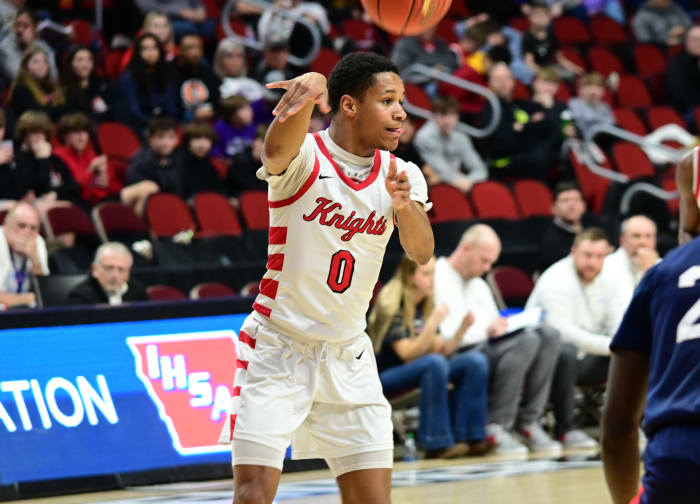Davenport Assumption's Damyen Jackson passes to a teammate against Ballard during a Class 3A state tournament quarterfinal game at Wells Fargo Arena in Des Moines on Tuesday. (Photo by Ryan Timmerman)